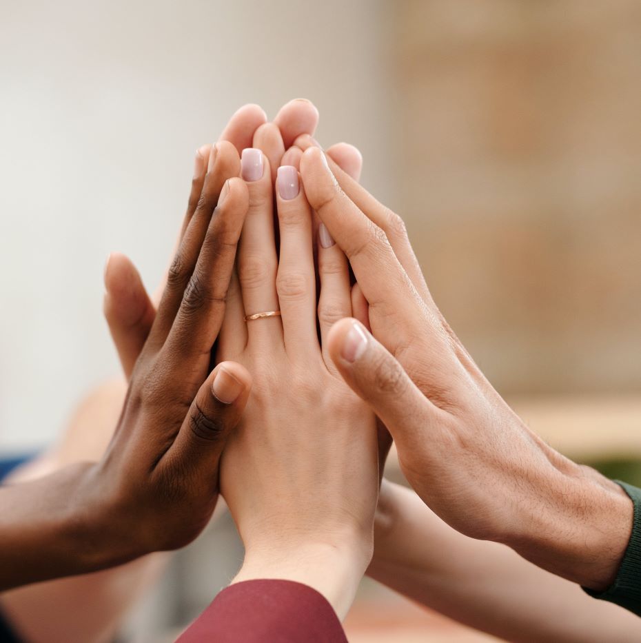 hands touching each other in support for group therapy